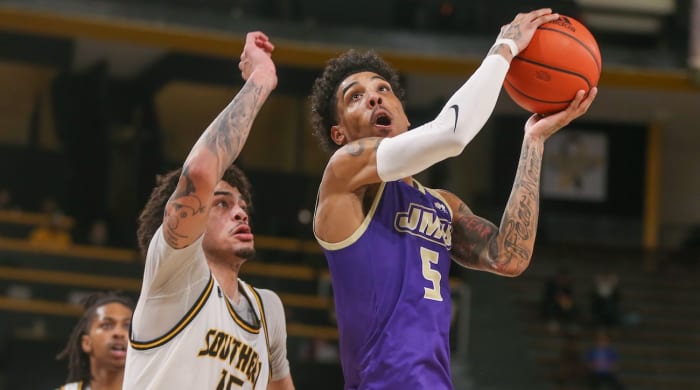 James Madison Dukes guard Terrence Edwards Jr. (5) is defended by Southern Miss Golden Eagles guard Donovan Ivory (15) during the first half at Reed Green Coliseum in Hattiesburg, Mississippi, on Jan. 6, 2024.